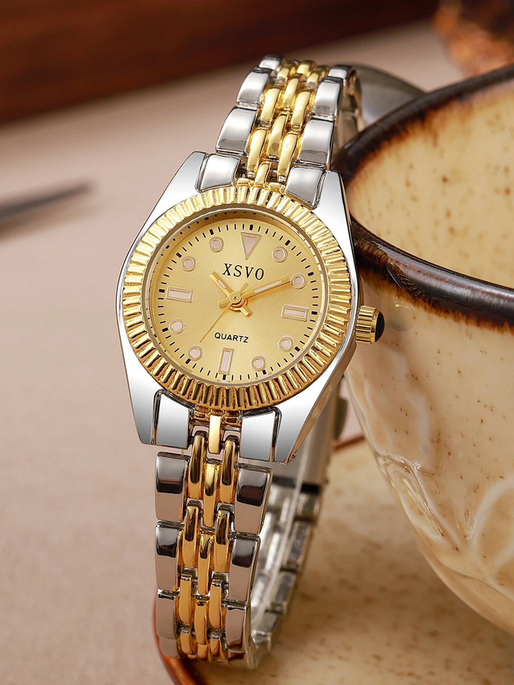 Luxury Two-Tone Women's Watch displayed next to a stylish cup, showcasing its elegant design and quartz movement.