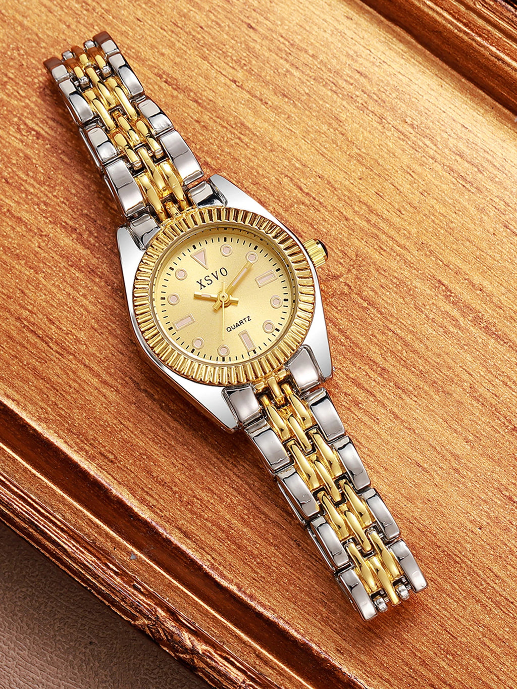Luxury Two-Tone Women's Watch displayed on a wooden surface, featuring a gold and silver band and round dial.